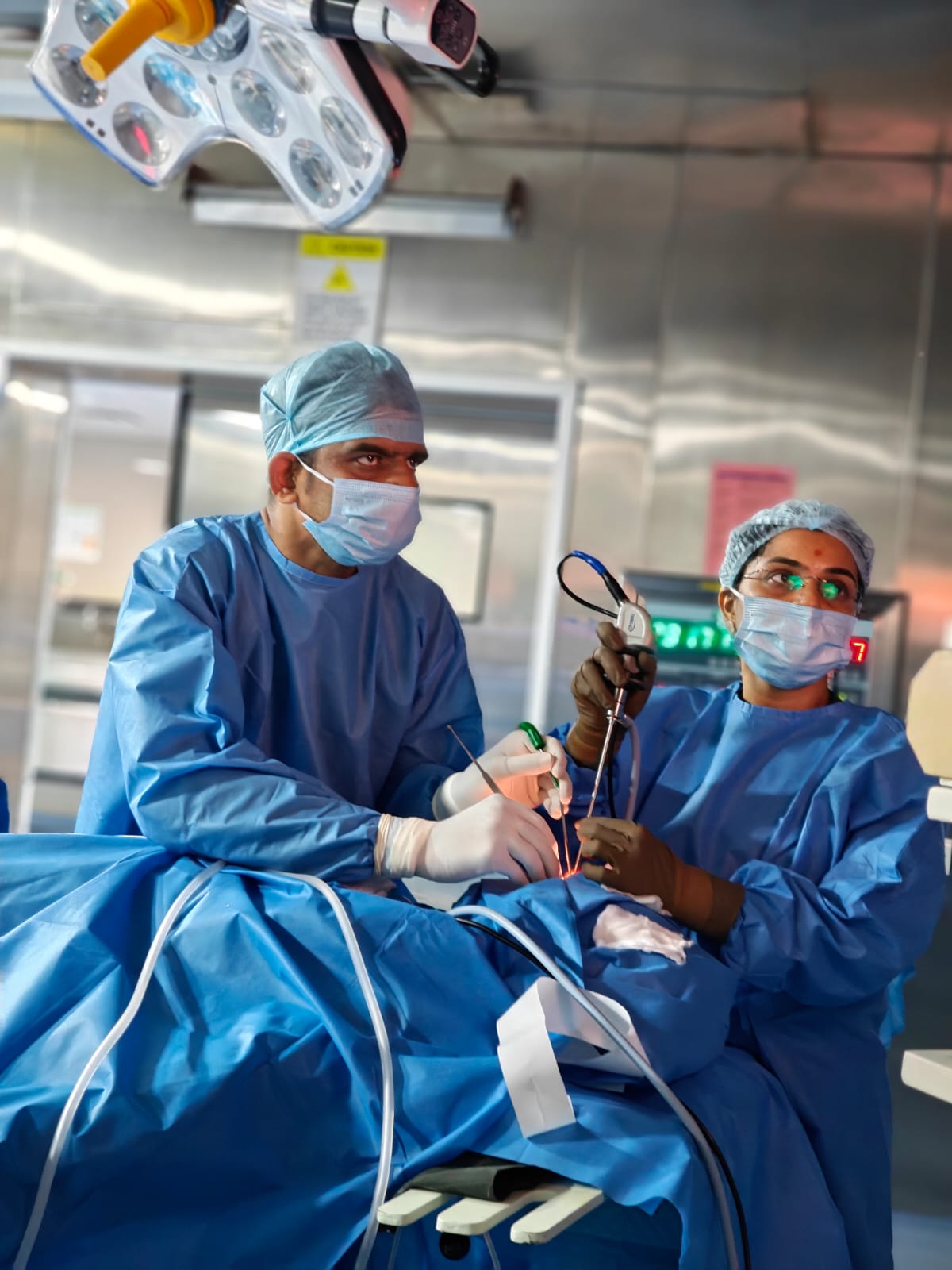 Surgeon and assistant performing endoscopic skull base surgery using the four-hand technique at CHESS Surgical Centre